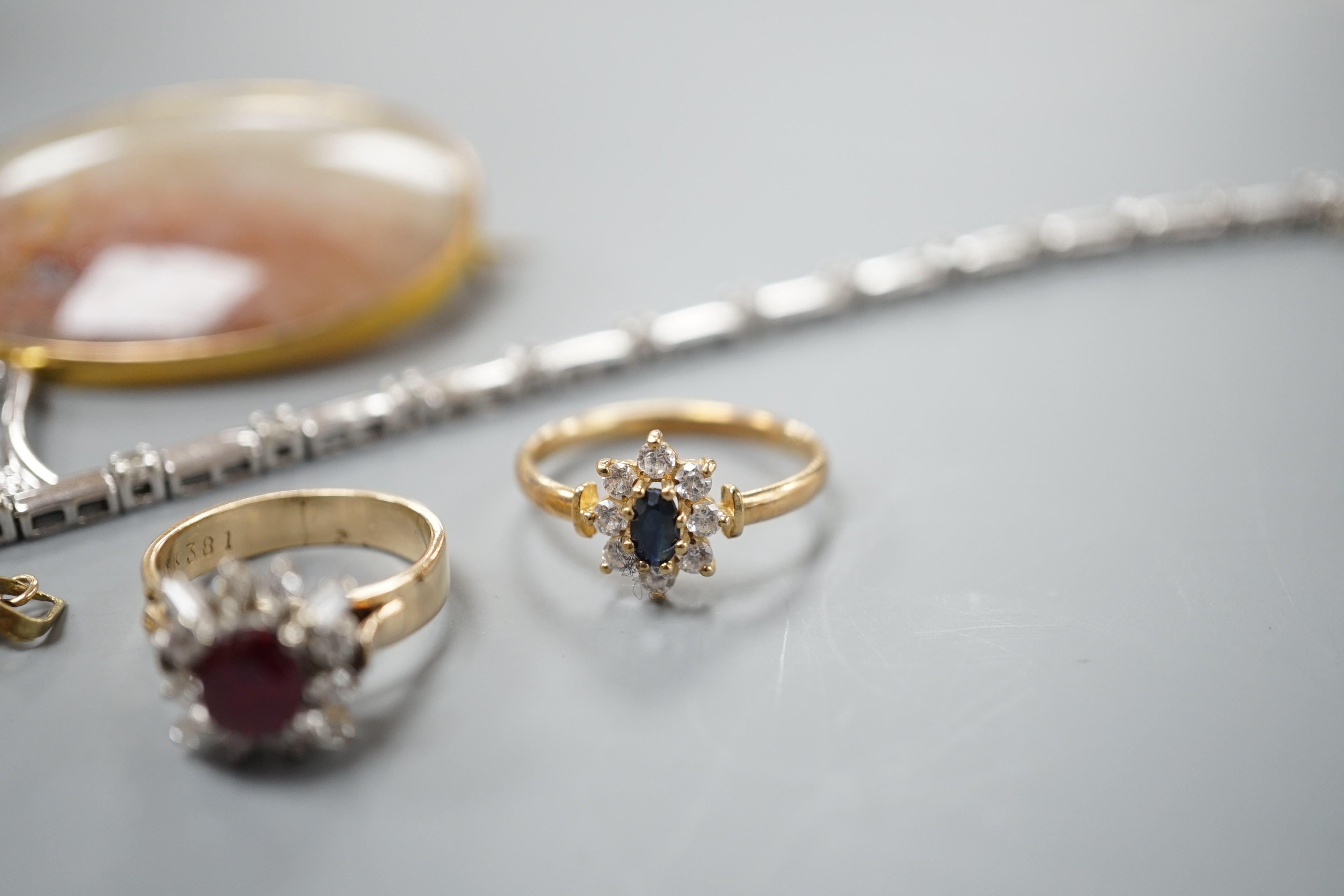 A 9kt white metal and diamond set bracelet, a 9ct mounted agate brooch, two rings including 18k, two pendants and a pair of modern diamond set ear studs.